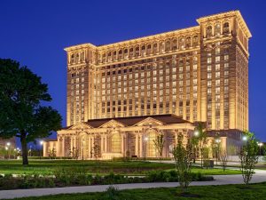 The newly renovated Michigan Central Station, lit up at night, June 2024.