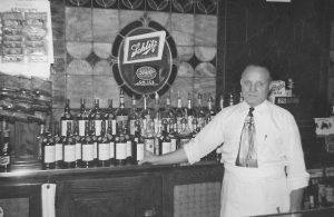 Jan (John) C. Michno standing at the bar of Michno’s Café shortly after he purchased the business, ca. 1939.