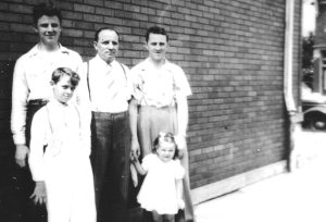 (Front, left to right): Loretta (daughter of Stella Michno and John Zaydel) and Bernard (Ben) Michno; (Back, left to right): Walter, John, and Tony Michno. Taken on the St. Stephen side of Michno’s Café before Tony and Walter joined the Army, ca. 1941.