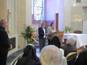 In accordance with tradition, Society Directors Alina Klin, Ph.D. (left), and Donna (Kutylowski) Czeski read aloud the names of all departed Society members during the Wypominki
