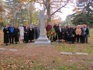 Pilgrims gather around the Felician Sisters’ monument in Holy Sepulchre Cemetery